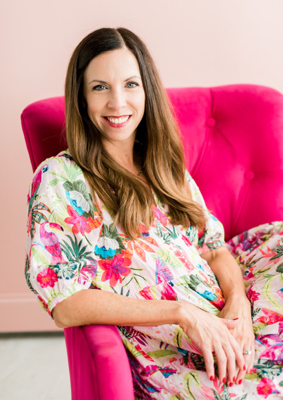 Bonney sitting on a pink chair