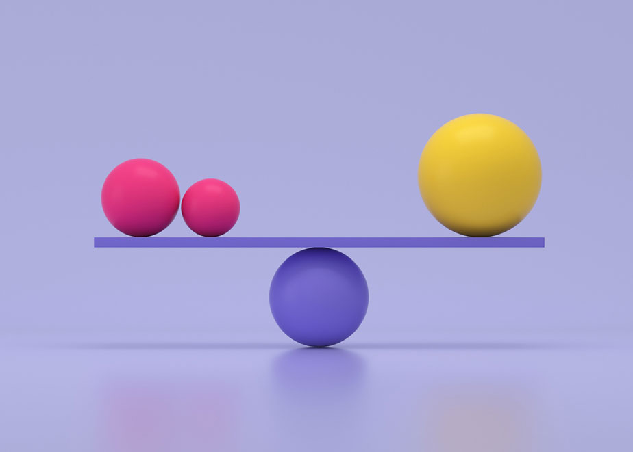 Two pink balls balanced by one larger yellow ball on purple balance beam